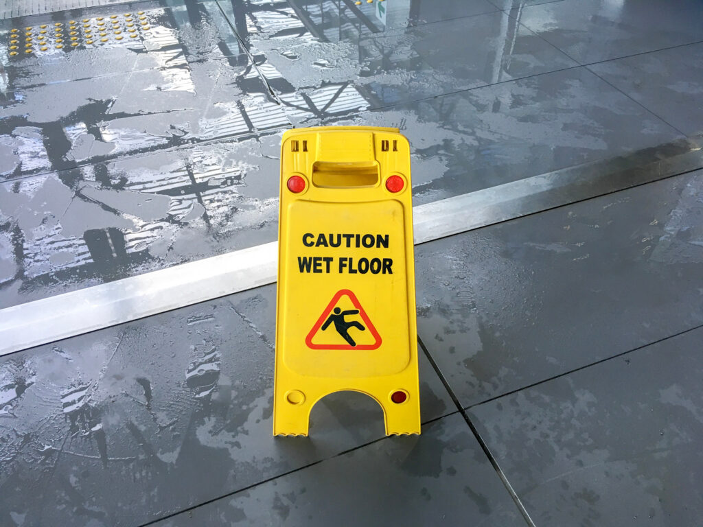 Wet floor caution sign warning of a slip and fall hazard