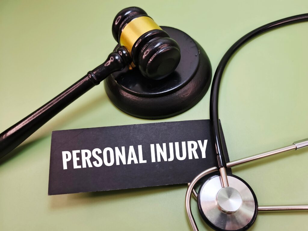 Gavel and stethoscope beside a "Personal Injury" sign symbolizing a legal claim